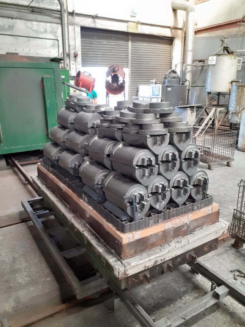 Glass mold castings stacked on a car in front of the annealing oven