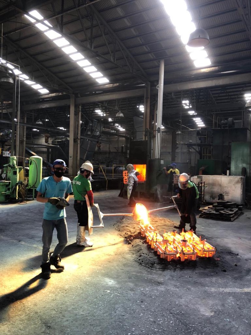 Sparks and molten stainless at the investment casting line