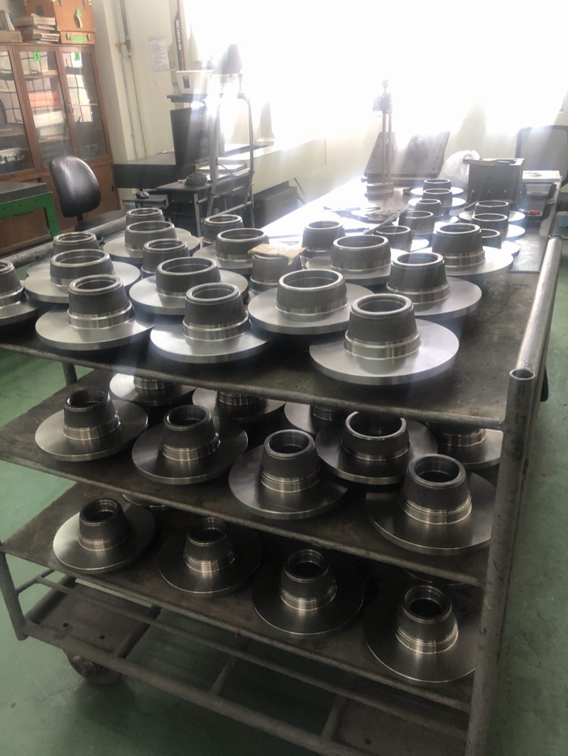Gray iron disc and hub castings stacked on racks at Metercor