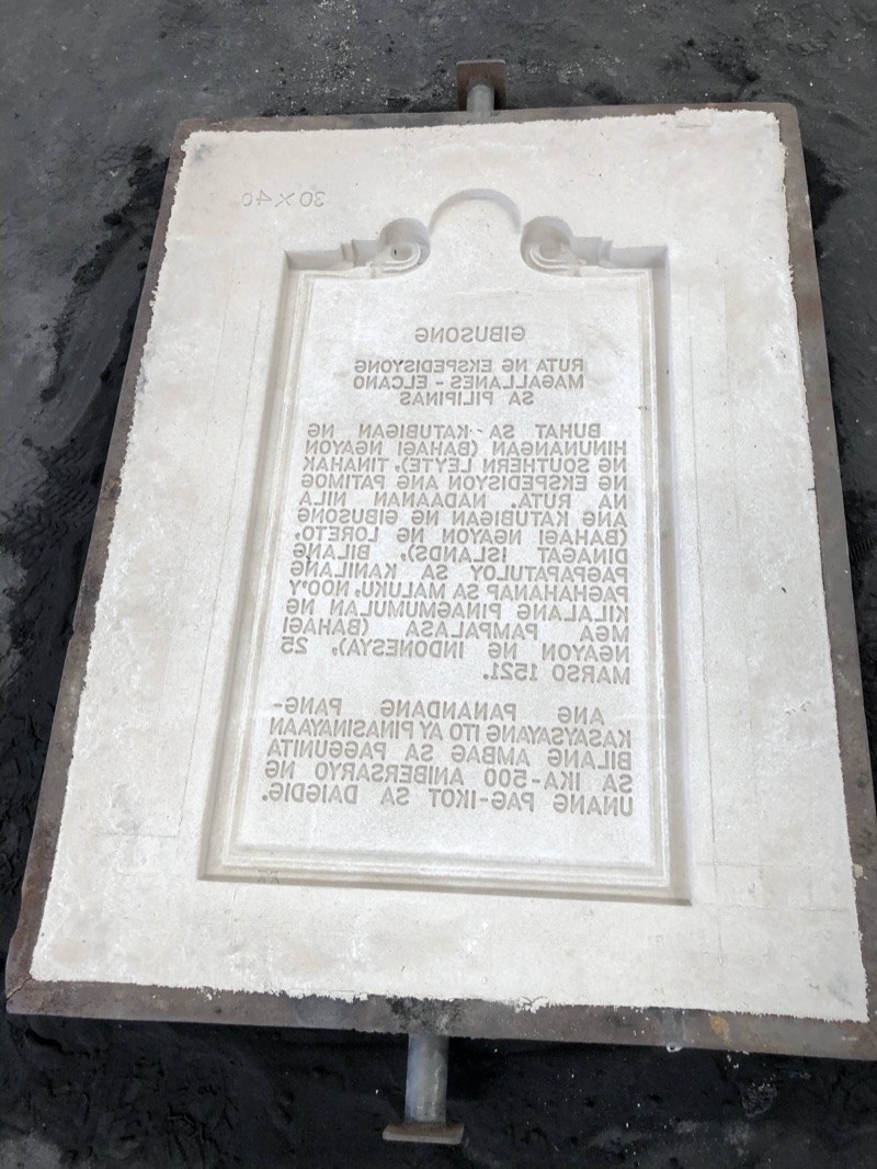 A finished cast marker plate with raised letters in its frame