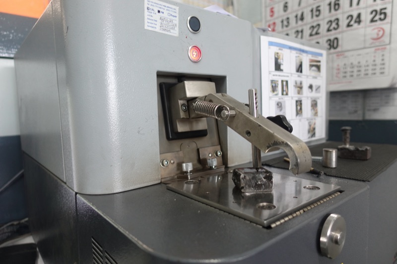 Spectrometer in the Metercor metal laboratory with a sample clamped for analysis